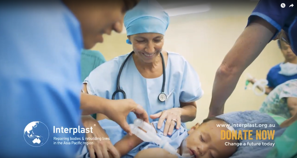 Nurse with asleep patient after surgery, there is an Interplast logo